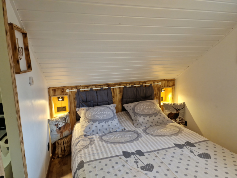 LEVEL 1 : BEDROOM 1 ATTIC WITH WARM DECORATION HIGH MOUNTAIN BED  160 X 190 + WARDROBE STORAGE WITH WINDOW OVERLOOKING THE MAGNIFICENT MOUNTAIN OF THE DEVOLUY. THIS ROOM IS ADJOINING ITS BATHROOM AND TOILET