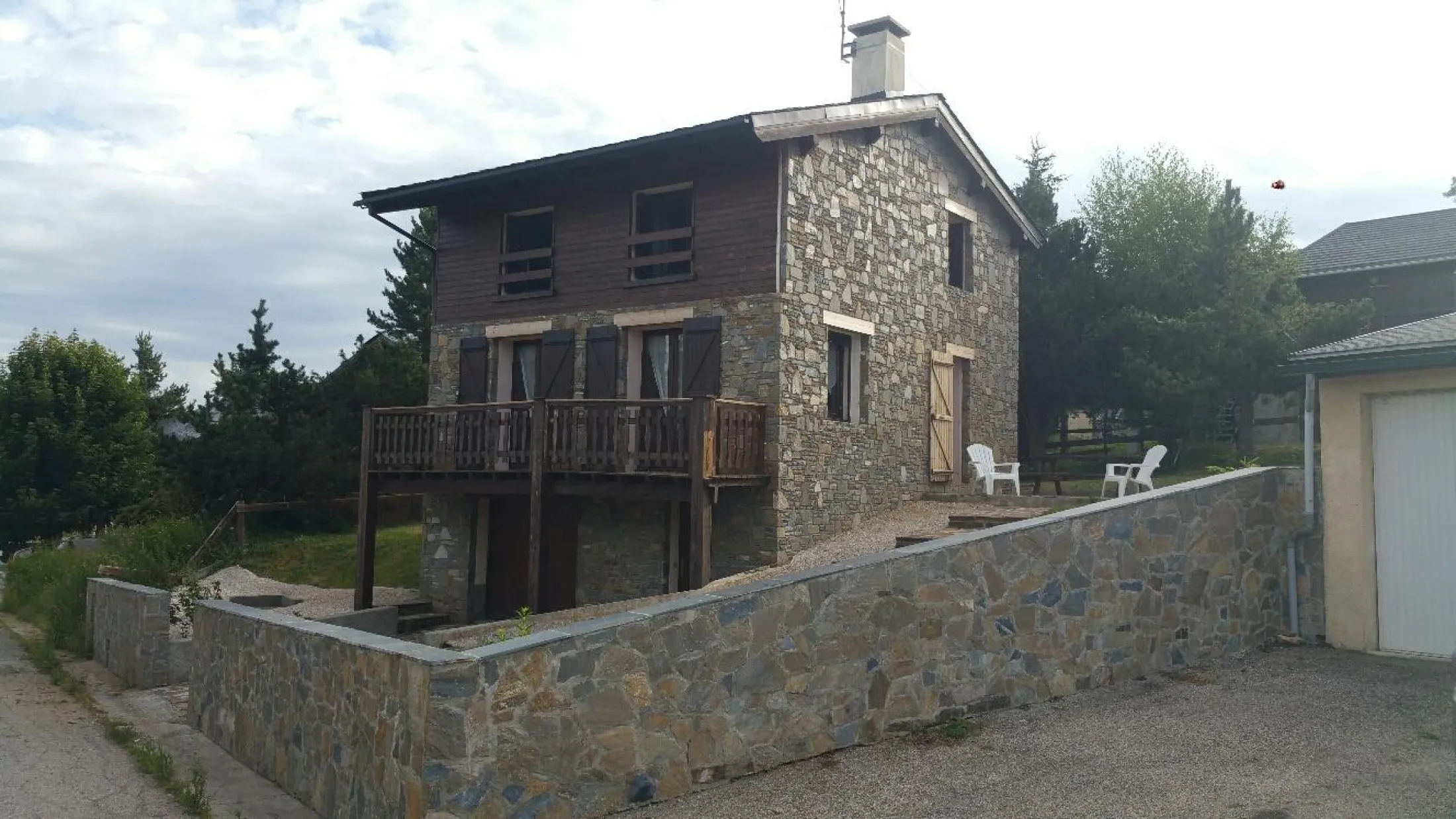 Agréable terrasse équipée de table de pique-nique, fauteuils, parasol, transats et barbecue pour l'été