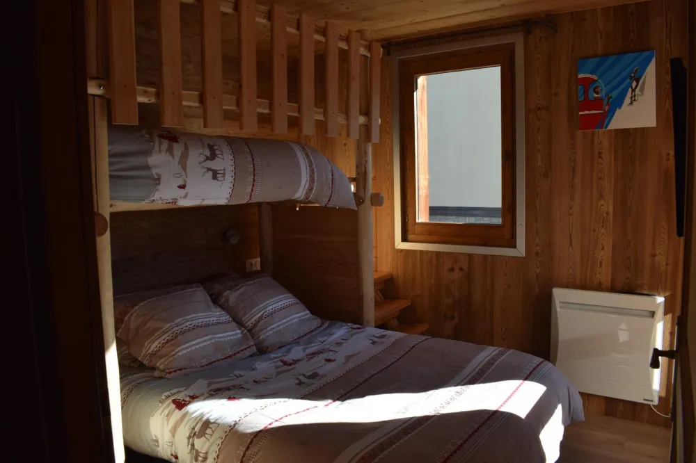 A bedroom with a double bed 140 and a single bed 90 on the mezzanine and television