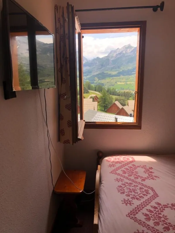 Bedroom with queensize bed and tv