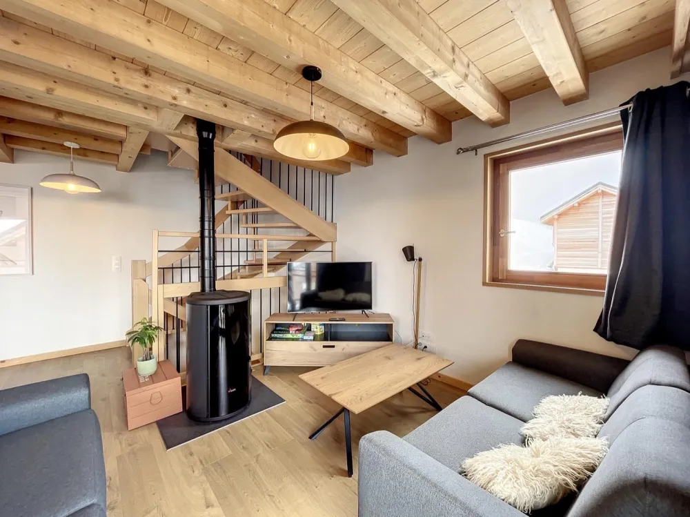 Living-room with television and a stove.