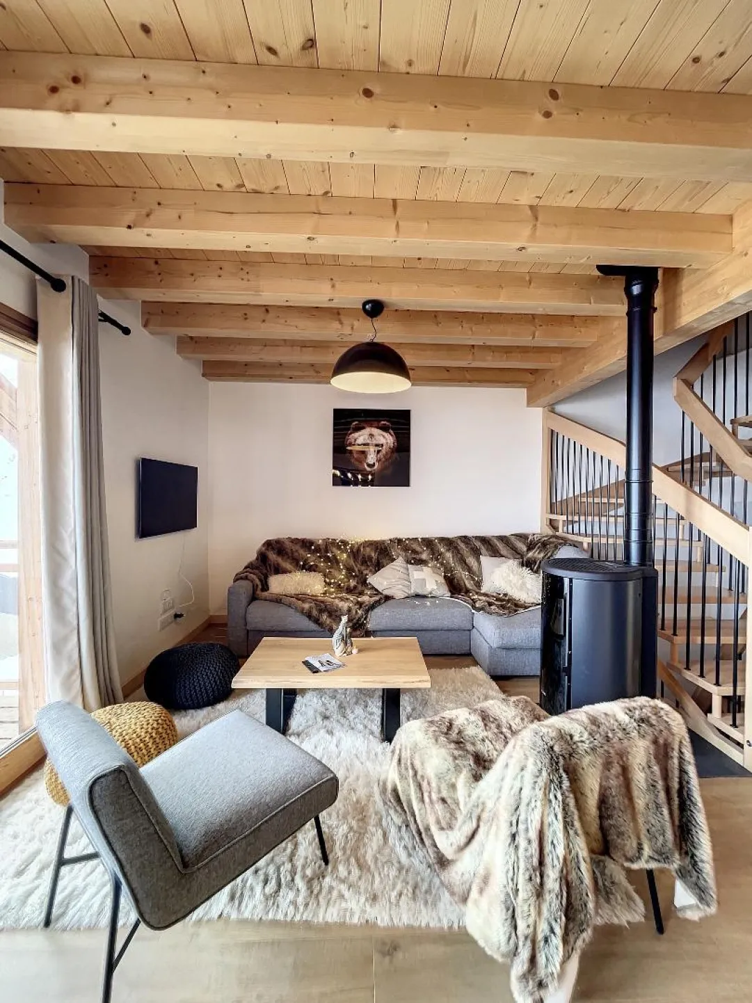 Living room with television and stove.