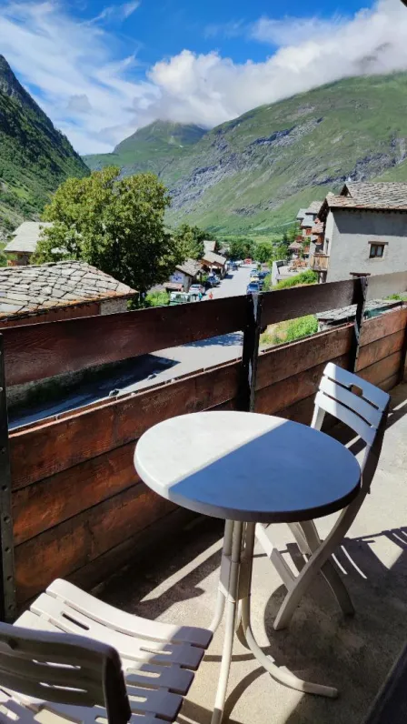 Balcony with  table and deck chairs.
