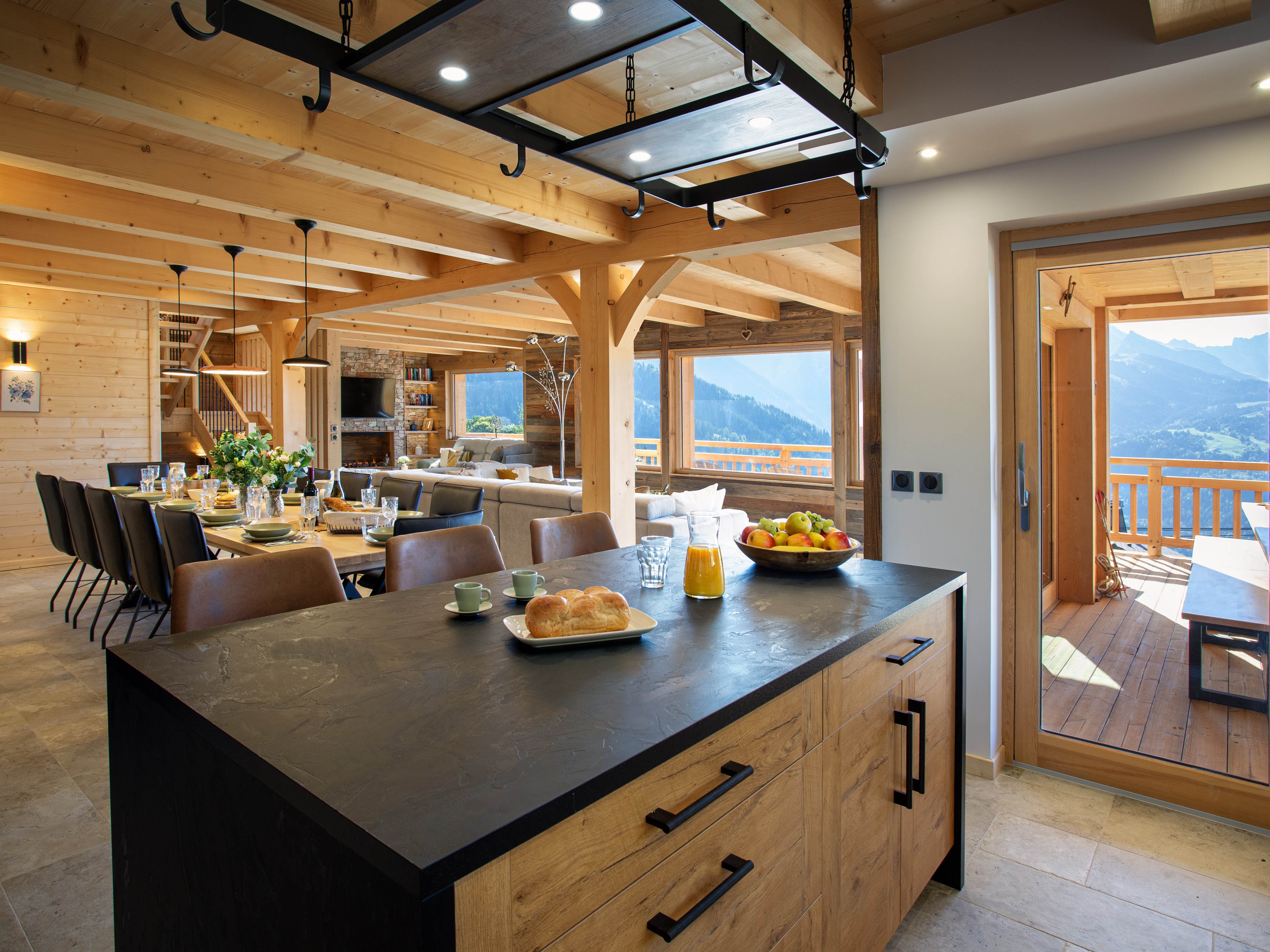 Cuisine spacieuse et entièrement équipée, ouverte sur le salon et les montagnes. Un espace raffiné où se mêlent confort, lumière naturelle et plaisir de cuisiner face aux sommets.