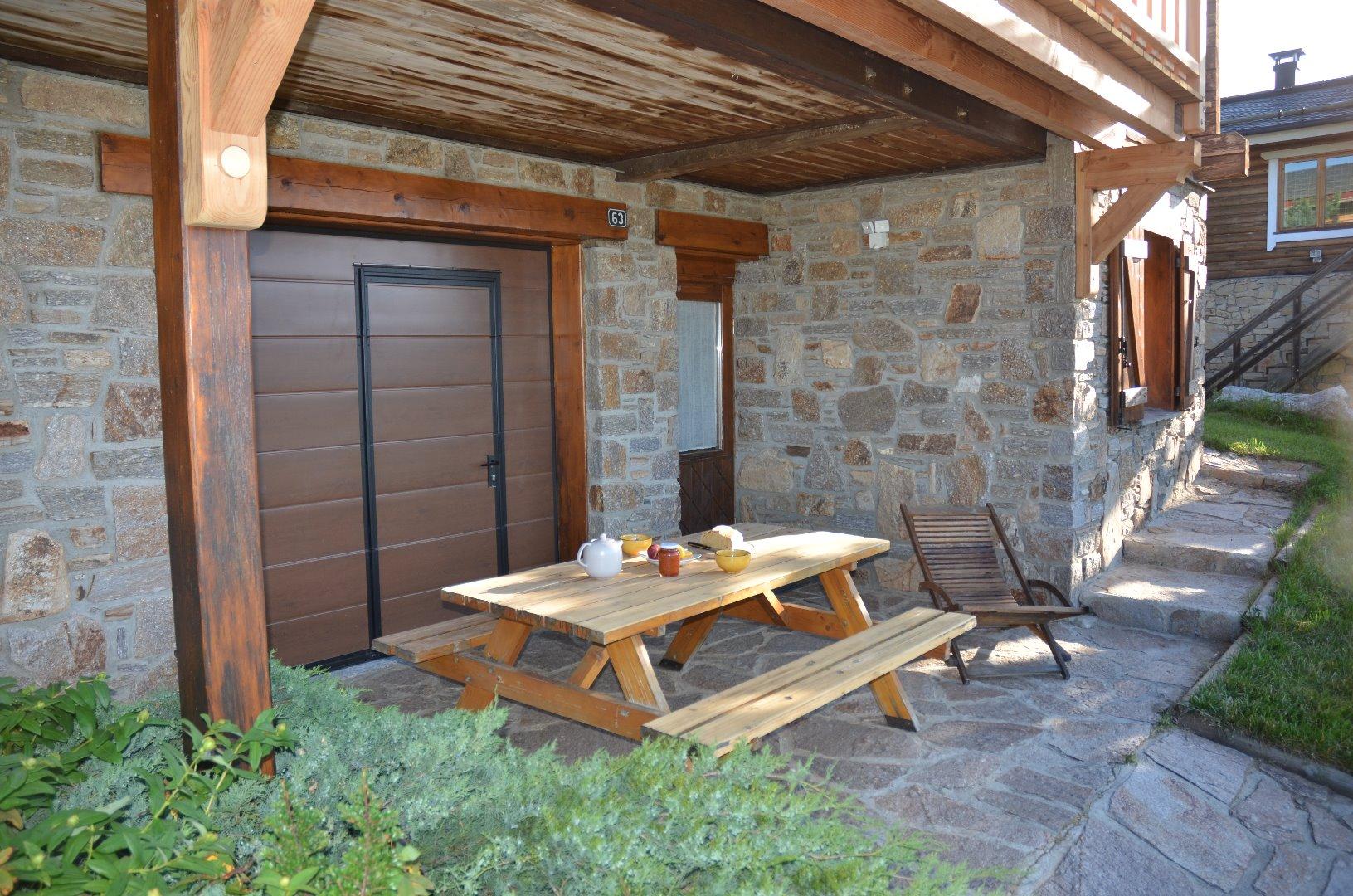 Bien à l’abri, la terrasse pour prendre vos petits-déjeuners et déjeuners, été avec parasol, hiver avec anorak.