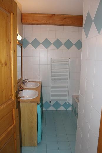 Appartement Bleu : salle de bain, deux vasques, avec baignoire. Il y a une autre salle de bain dans l'appartement, avec une douche.