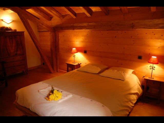 une des trois chambre à l'étage, tout en bois, avec ses vieilles poutres apparentes qui donnent un cachet certain et une ambiance chaleureuse